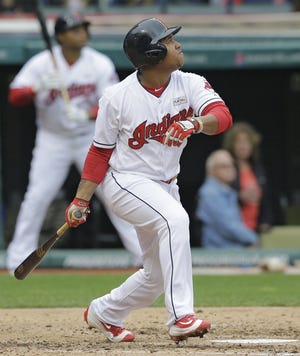 The Indians' Jose Ramirez keeps an eye on the ball after hitting an RBI single off Twins starting pitcher Ervin Santana in the fourth inning, scoring Mike Napoli.