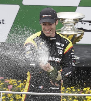 Simon Pagenaud of Team Penske celebrates with a champagne shower after winning the Grand Prix of Indianapolis, which came on the heels of victories at Long Beach and Alabama.