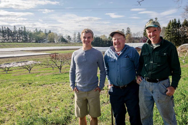 ADVANCE FOR WEEKEND EDITIONS MAY 7-8 - In this April 29, 2016 photo, John Gove, 17 with his grandfather Warren Gove, center, and father, Paul Gove, pose for a photo at the family farm in Leominster, Mass. A study released recently by American Farmland Trust and Land for Good shows that nearly one-third of Massachusetts farms are owned or managed by farmers 65 or older, and most of them don't have someone they're training to take over. Lisa and Paul Gove plan to eventually pass the fruit and vegetable farm along to their 17-year-old son John, who will attend an agricultural college after graduating from high school. (Ashley Green/The Sentinel & Enterprise via AP) MANDATORY CREDIT