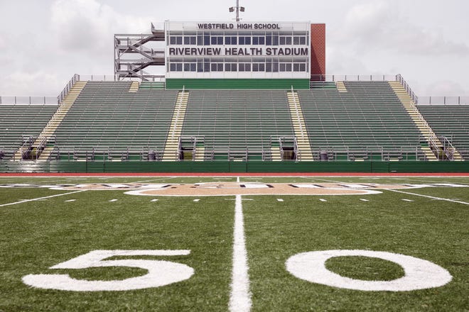 — AP photos by MICHAEL CONROY

Westfield High School near Indianapolis agreed to deals in 2014 to fund a football stadium that opened last year. The stadium and gates bear business’ names.