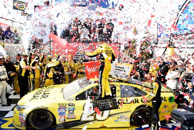 Matt Kenseth, center, celebrates in Victory Lane after he won the NASCAR Sprint Cup series auto race, Sunday, May 15, 2016, at Dover International Speedway in Dover, Del. (AP Photo/Nick Wass)