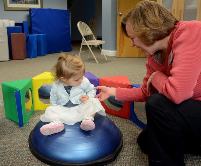 Michelle Smith, a pediatric physical therapist at Lighthouse Physical Therapy, does a gross motor skills screening on 15-month-old Xenia Maria Rossetti. 

Suzanne Laurent photo