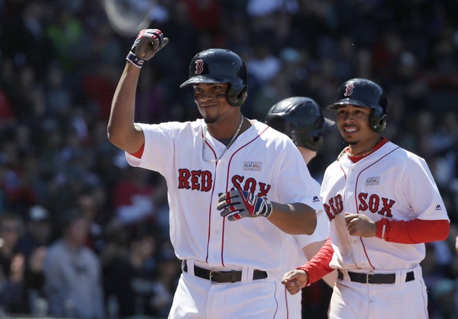 Boston Red Sox hitter Xander Bogaerts, left, celebrates his three-run home run in the second inning of a baseball game at Fenway Park Sunday against the Houston Astros in Boston. Photo by AP