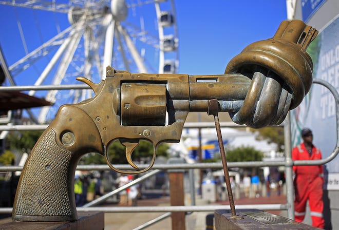 In this Tuesday, Feb. 26, 2013 file photo, a sculpture by Carl Fredrik Reutersward, titled "knotted gun" which is a symbol designed to protest against global violence and senseless killings, is displayed in Cape Town, South Africa. Carl Fredrik Reutersward, one of Sweden´s best-known modern artists and the creator of the iconic statue of a revolver barrel tied in a knot, has died. He was 81. Thomas Millroth, from the Carl Fredrik Reutersward Art Foundation, said the artist died in a hospital in Helsingborg, southwestern Sweden on Tuesday, May 3, 2016. No cause of death was given.(AP Photo/Schalk van Zuydam, file)