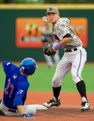 K-State shortstop Tyler Wolfe turns a double play over KU's Devin Foyle in the top of the ninth inning Sunday at Tointon Family Stadium in Manhattan.