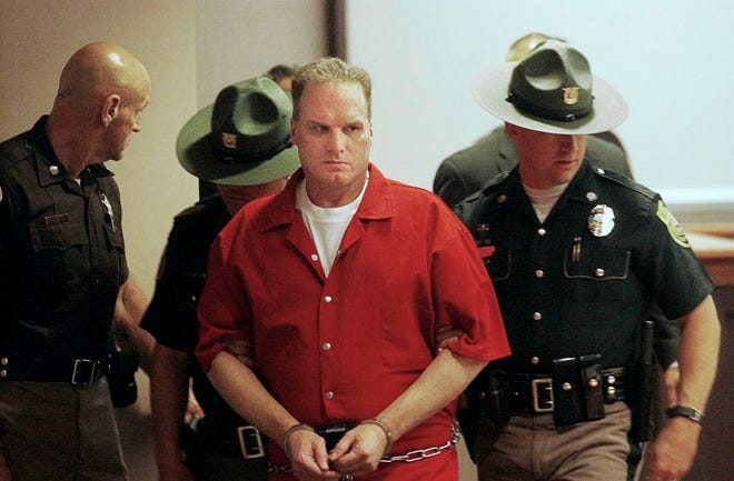 Gary Sampson, center, seen in this file photo taken Tuesday, June 1, 2004, is escorted into Hillsborough County Superior Court in Nashua, N.H. Sampson was sentenced to death in 2003 after he carjacked Jonathan Rizzo, 19, and Taunton's Philip McCloskey, 69, then slit their throats.