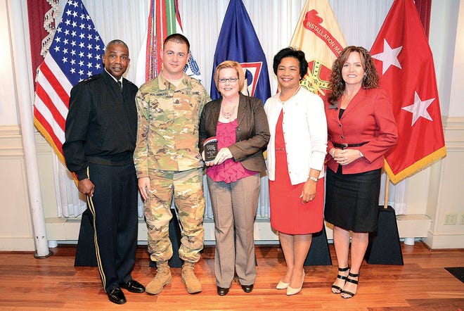 Michele Maldonado holds her Spouse of the Year award and poses with Maj. Gen. Darrell K. Williams, CASCOM and Fort Lee commanding general; Sgt. 1st Class David Maldonado, 262nd Quartermaster Battalion; Myra Williams, wife of the senior commander; and Maggie Hahn, military affairs relationship director, military advocacy, USAA, on May 4 at the Lee Club. Lesley Maceyak/Fort Lee Public Affairs