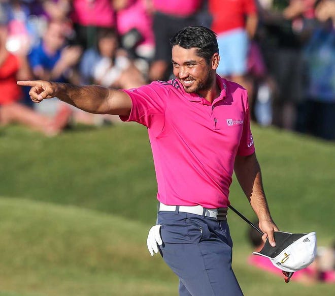 Gary McCullough/Correspondent Jason Day points at his son running onto the 18th green after Day won The Players Championship on Sunday on the Stadium Course at TPC Sawgrass in Ponte Vedra Beach.