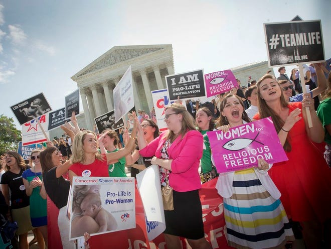 In this June 30, 2014 file photo, demonstrators react to hearing the Supreme Court's decision on the Hobby Lobby birth control case outside the Supreme Court in Washington. The Supreme Court rid itself Monday, May 16, 2016, of a knotty dispute between faith-based groups and the Obama administration over birth control. The court asked lower courts to take another look at the issue in a search for a compromise. (AP Photo/Pablo Martinez Monsivais, File)