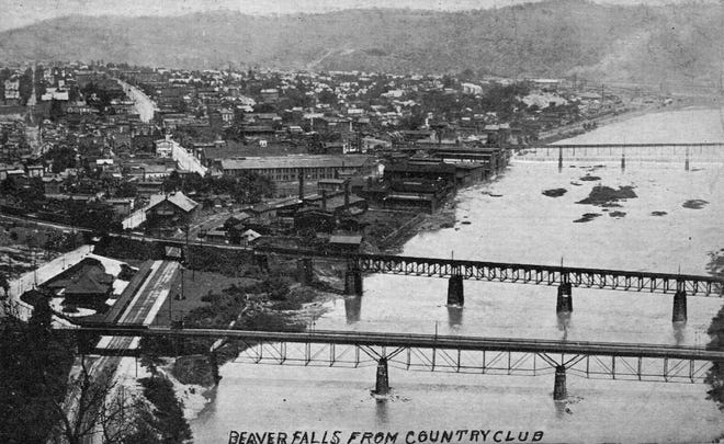 A view of Beaver Falls from the Beaver County Country Club, circa 1915. This photograph was one of many used by local businessmen as postcard images during the early 1900s. The old wooden toll bridge has been replaced with the 1901 steel span, and much of the riverfront properties were home to industrial concerns