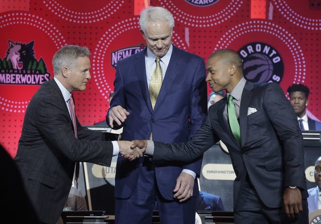 Philadelphia 76ers head coach Brett Brown, left, is congratulated by Boston Celtics guard Isaiah Thomas, right, and Los Angeles Lakers general manager Mitch Kupchak after the 76ers won the top draft pick during Tuesday night's lottery selection. Julie Jacobson/Associated Press