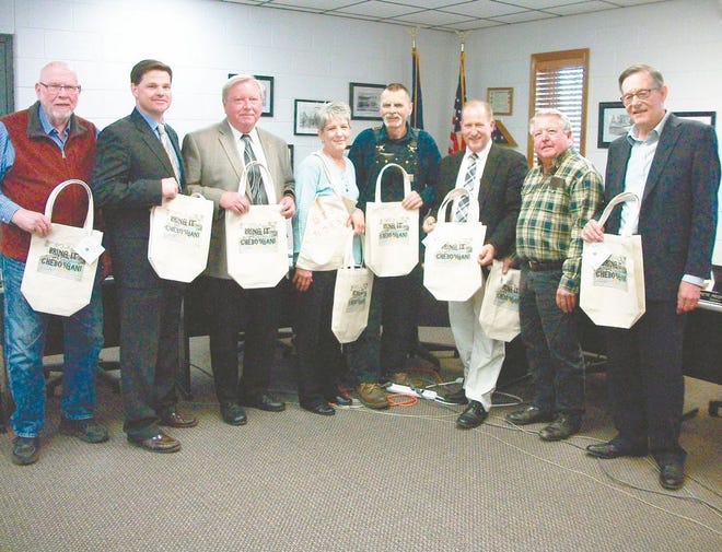 Cheboygan County officials were given a Bring it Cheboygan reusable shopping bag by local advocate Karen Martin as part of a local campaign to encourage reduced use of plastic shopping bags. Pictured from left: County commissioner John Wallace, county administrator Jeff Lawson, county board chair Pete Redmond, county board vice-chair Sue Allor, commissioner Tony Matelski, commissioner Chris Brown, commissioner Cal Gouine and commissioner Bruce Gauthier.