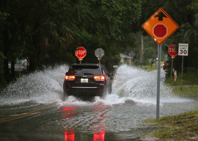Cars make their way down a partially flooded street in Daytona Beach after a heavy rain, Tuesday, May 17, 2016. News-Journal/NIGEL COOK
