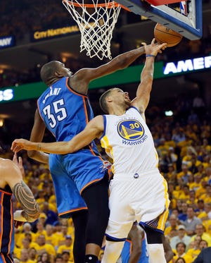 Thunder forward Kevin Durant blocks a shot by Warriors guard Stephen Curry during the fourth quarter of Monday night's Game 1 of the Western Conference Finals in Oakland, Calif. [Photo by Nate Billings, The Oklahoman]