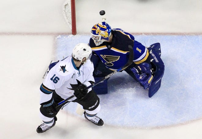 Sharks center Nick Spaling watches teammate Tommy Wingels' shot beat St. Louis Blues goalie Brian Elliott in the first period of San Jose's 4-0 win Tuesday night. JEFF ROBERSON/THE ASSOCIATED PRESS