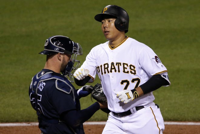 The Pirates' Jung Ho Kang (27) cross home plate past Atlanta Braves catcher Tyler Flowers after hitting a solo-home run off reliever Arodys Vizcaino in the ninth inning on Wednesday in Pittsburgh. The Braves won 3-1.