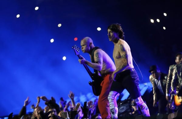 Flea, left, and Anthony Kiedis of the Red Hot Chili Peppers perform at halftime of the 2014 Super Bowl.