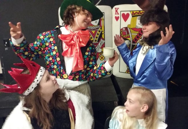 Wearing some of the costumes from "Alice In Wonderland" are, clockwise from left, Madison Mead (Queen of Hearts), Isaac Jordan (Mad Hatter), Frank Out (March Hare) and Hannah Douglas (Alice). NEWS-JOURNAL/SHAUN RYAN