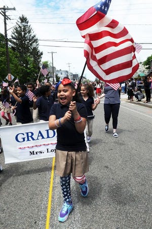 Isabela Plummer, 8, wearing her red, white, and blue socks during the 119th Annual Huntington School Memorial Day Parade on Thursday, May 19, 2016.