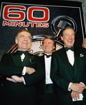 In this Nov. 10, 1993 file photo, The "60 Minutes" team, from left, Morley Safer, Steve Kroft and Mike Wallace pose at the Metropolitan Museum of Art in New York celebrating their 25th anniversary. Safer, the veteran “60 Minutes” correspondent who exposed a military atrocity in Vietnam that played an early role in changing Americans’ view of the war, died Thursday, May 19, 2016. He was 84.