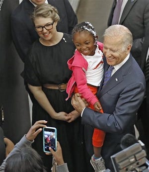 Jeni Britton Bauer helps to lead Vice President Joe Biden on a tour of the North Market where he stopped to take photographs with shoppers, Wednesday, May 18, 2016 in Columbus, Ohio. More than 4 million U.S. workers will become newly eligible for overtime pay under rules issued Wednesday by the Obama administration. The rule seeks to bolster overtime protections that have been eroded in recent decades by inflation. (Chris Russell/The Columbus Dispatch via AP) MANDATORY CREDIT