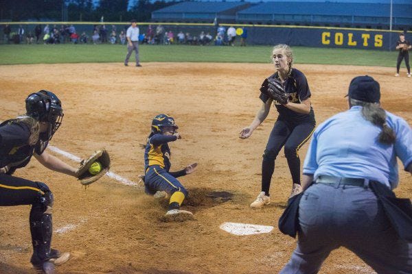 Haley Cashwell slides home to score the Colts' third run during Wednesday's win over Apex. Cape Fear scored 10 runs in the victory, equaling their total offensive output from their last three games combined. The Colts (26-0) will host Fuquay-Varina (19-3) on Friday in the fourth round. Below, winning pitcher Aubrey Reep winds up. 'She hit 95 percent of her spots tonight,' Cape Fear co-coach Jeff McPhail said of his ace.