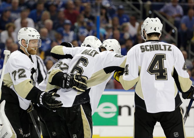 The Penguins' Trevor Daley (6) is helped up by teammates Patric Hornqvist (72), Sidney Crosby (87) and Justin Schultz (4) after he was injured during the second period of the Pegnuins' Game 4 loss to Tampa Bay on Friday night in Tampa, Fla. With the 4-3 loss to the Lightning, the series is tied, 2-2.