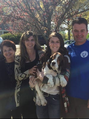 The Boudreau family of Shrewsbury prepares to go home with Lassie, a 10-year-old cocker spaniel adopted from the MSPCA Cape Cod. Jim, Hannah and Kristen, from right, shown with Kristen's mother, Joan Lourie, previously had a blind and deaf dog, according to Kristen, and so they knew what to expect with Lassie, who recently had to have her eyes surgically removed. Photo courtesy of MSPCA Cape Cod