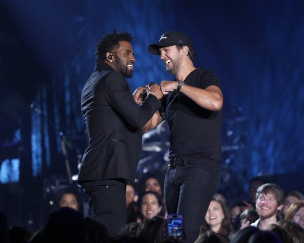 Jason Derulo, left, and Luke Bryan perform during a March 29 taping of an episode of "CMT Crossroads"
