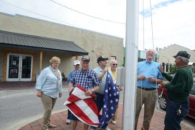 Mike Tribula, G.I. Joe’s vice chairman and veteran Eric Cantu share a laugh as they rehearse raising the flag with other veterans and friends at their new flag pole behind G.I. Joe’s on Herritage Street.