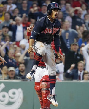 Cleveland's Francisco Lindor celebrates after scoring on a sacrifice fly by Jose Ramirez during the third inning of Friday night's Indians win at Fenway Park.