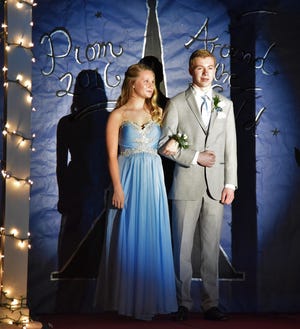 Rebecca Wheeler is escorted by Jason Waleryszak during the junior prom grand march on Friday evening at Newmarket High School. 

Photo by Sasha Jost/Fosters.com