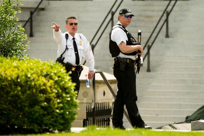 A Secret Service agent orders people into buildings near the entrance to the West Wing of the White House in Washington, Friday, May 20, 2016, after the White House was placed on security alert after shooting on street outside. (AP Photo/Andrew Harnik)