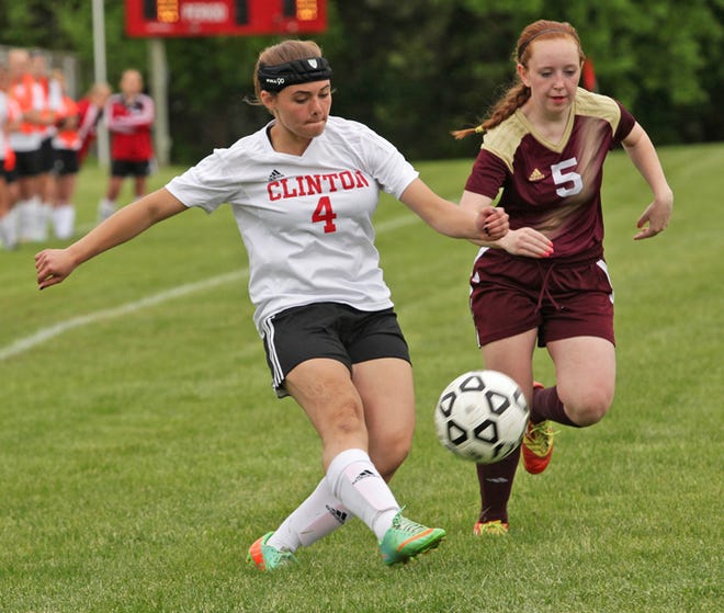 Clinton sophomore Faith Ford (4) dribbles against Manchester's Sirona Brower during Friday's game.
