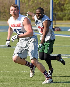 Cortezz Nixon (right), a Gastonia native who played college football at UNC Charlotte, plays close to Zachary Allan during a 1-on-1 drill at the Montreal AlouettesþÄô open tryouts, held Saturday, May 7, 2016, at Mooresville High SchoolþÄôs Coach Joe Popp Stadium. Nixon, who played high school ball at Forestview was among 160-plus players taking part in the open tryout for a potential roster spot with the Canadian Football League team. Bill Kiser / Special to the Gazette