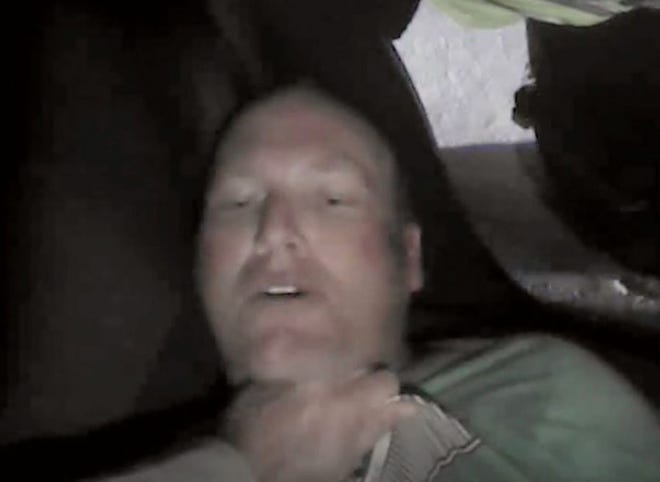 This Nov. 20, 2015, frame grab from video taken from a body camera worn by a Coweta County, Ga., Sheriff's Department deputy shows Chase Sherman, 32, of Destin, Fla., being held down by a deputy in the back seat of a car outside Atlanta. Deputies who responded to a call from Sherman's mother attempted to subdue Sherman by using electronic control devices. Then they realized Sherman has stopped breathing and moved him out of the vehicle. Sherman was pronounced dead at a hospital later that day. (Coweta Country District Attorney's Office via AP)