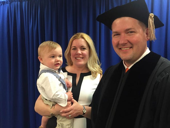 Before Champe Carter Speidel received his honorary doctoral degree from Johnson & Wales University and spoke at its graduation ceremony Saturday afternoon in Providence, he and his wife, Lisa, who own Persimmon and Persimmon Provisions, pose with their son, Thatcher.