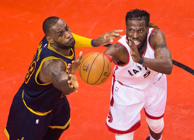 Cleveland Cavaliers forward LeBron James, left, and Toronto Raptors forward DeMarre Carroll (5) battle for the ball during the second half of Game 3 of the NBA basketball Eastern Conference finals in Toronto on Saturday, May 21, 2016. (Nathan Denette/The Canadian Press via AP) MANDATORY CREDIT