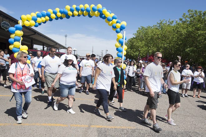 CHIEFTAIN PHOTO/JOHN JAQUES People leave the starting line for the Mental Health Walk held in Pueblo on Saturday.