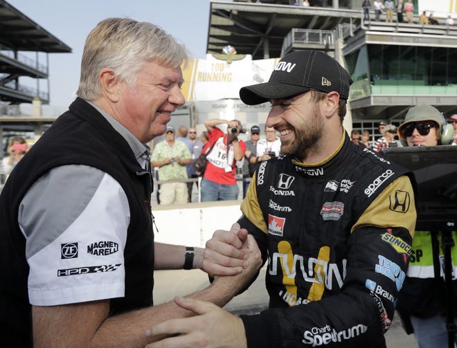 James Hinchcliffe, right, celebrates with a crew member after posting the top speed in the top-nine qualifying round. He will run for the pole today.