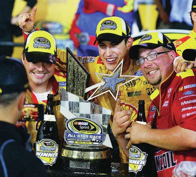 NASCAR Sprint Cup Series driver Joey Logano, middle, celebrates with crew members after claiming victory in the NASCAR Sprint All-Star race on Saturday at Charlotte Motor Speedway in Concord, N.C. (Jeff Siner/Charlotte Observer/TNS)