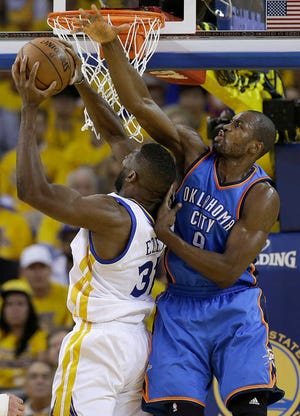 Golden State Warriors center Festus Ezeli (31) shoots against Oklahoma City Thunder forward Serge Ibaka (9) during Game 2 of the Western Conference finals in Oakland, California, on Wednesday.
