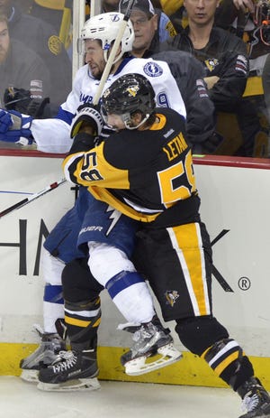 Kris Letang (58) checks Tyler Johnson into the boards during the third period of Game 5 of the Eastern Conference final on Sunday at Consol Energy Center in Pittsburgh.