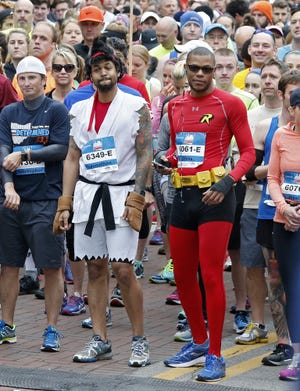 Capital City Half Marathon: Jonathan Smith, center left, as a "Street Fighter" character and Chris Glover as Robin (of "Batman" fame)