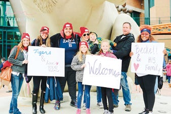 Siena Heights University student Tiffany Faz, third from left, is pictured April 28 with members of her Love Your Melon group and Beckett Zehnder, 5, and his family at Comerica Park in Detroit. The group treated Beckett, who is battling cancer, to a “superhero” day at the ballpark.