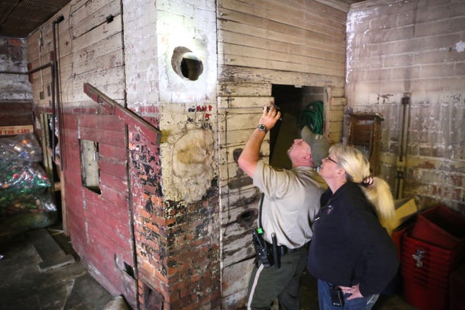 Lt. Tom Fransen, of the Carroll County, Iowa, Sheriff's office, shines a flashlight into a chimney at Carroll Redemption Center, in Carroll, Iowa, where Jordan Kajewski, 29, was stuck. Kajewksi crawled into the chimney during the night of May 17, 2016, and was rescued the following day. He was naked and covered in soot, though he had his clothes with him. Kajewski was charged with trespassing. (Jared Strong/Carroll Daily Times Herald via AP)