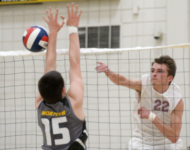 Ambridge's Adam Fryer hits a shot as a Montour volleyball player defends during their WPIAL Class AA semifinal Tuesday at North Allegheny High School.