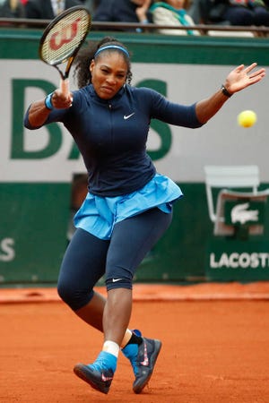 Serena Williams returns the ball during her first-round match at the French Open against Magdalena Rybarikova on Tuesday at Roland Garros stadium in Paris. Williams won 6-2, 6-0. (AP Photo/Alastair Grant)