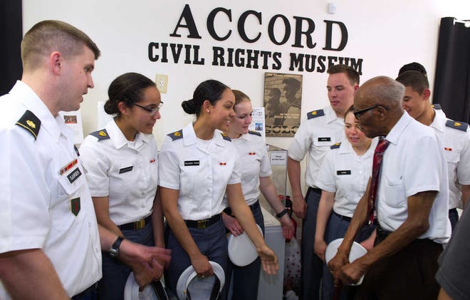 PETER.WILLOTT@STAUGUSTINE.COMCadets from the U.S. Military Academy in West Point, New York talk to 97-year-old U.S. Army World War II veteran Sollie Mitchell as they tour the ACCORD Civil Rights Museum in St. Augustine on Tuesday, May 24, 2016. The cadets stopped at the museum during a tour of important civil rights locations in the county. Mitchell served in the 8th Army during World War II.