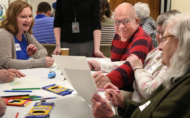 Chuck Hansen of Taylorville, right, makes a humorous observation about the artwork of Nancy Junker of Jerome, front right, during the "Art Express" class for people with Alzheimer's disease and other forms of dementia at Hope Presbyterian Church on Wednesday, March 23, 2016. David Spencer/The State Journal Register